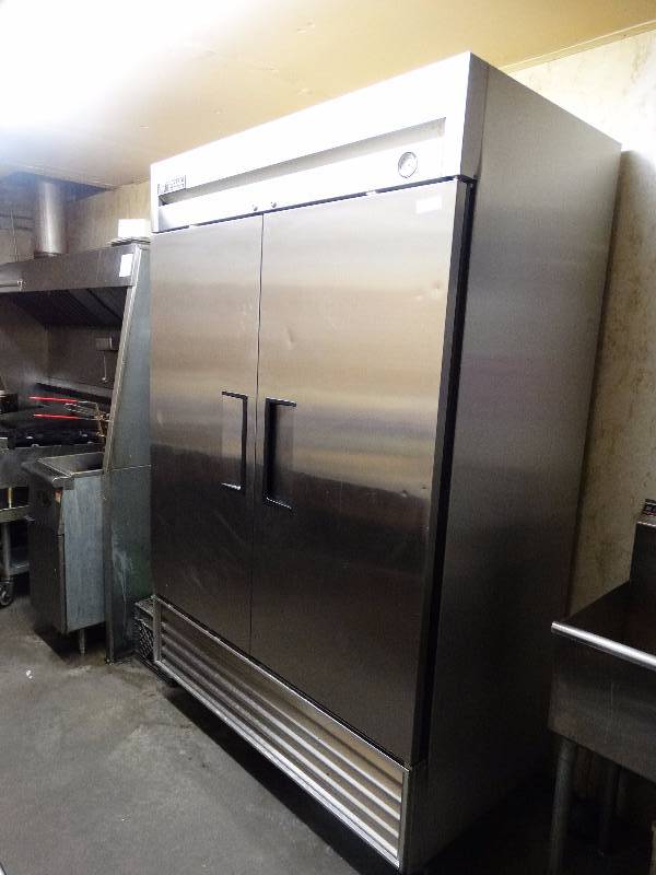 lot 729 image: True Commercial Stainless Steel  2-door refrigerator. Model T-49. on casters. Great shape & works as should.