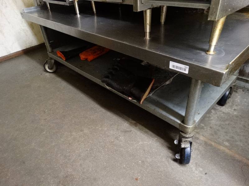 lot 763 image: 5 foot Stainless Steel equipment stand on wheels.