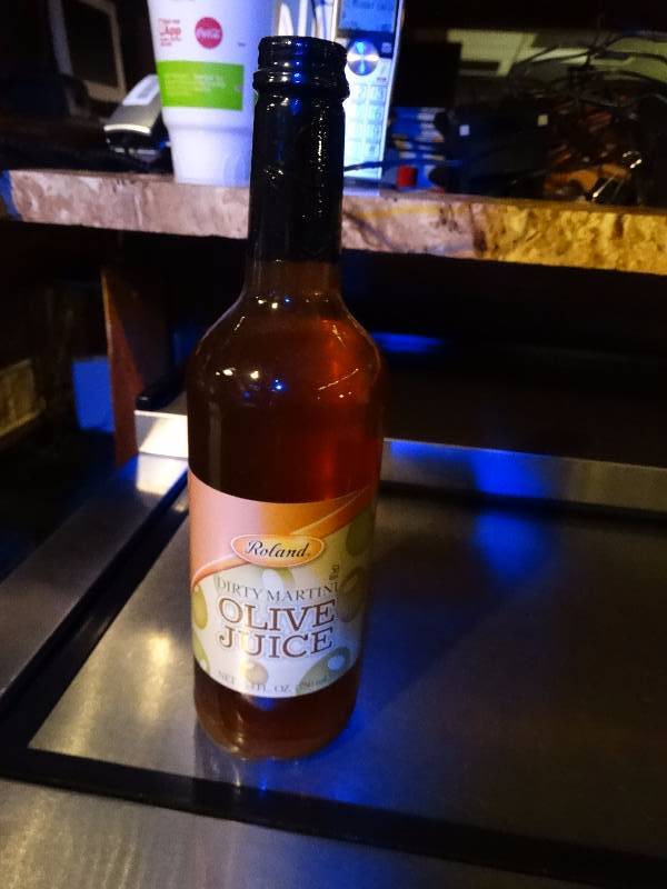 lot 898 image: Unopened bottle of Olive juice