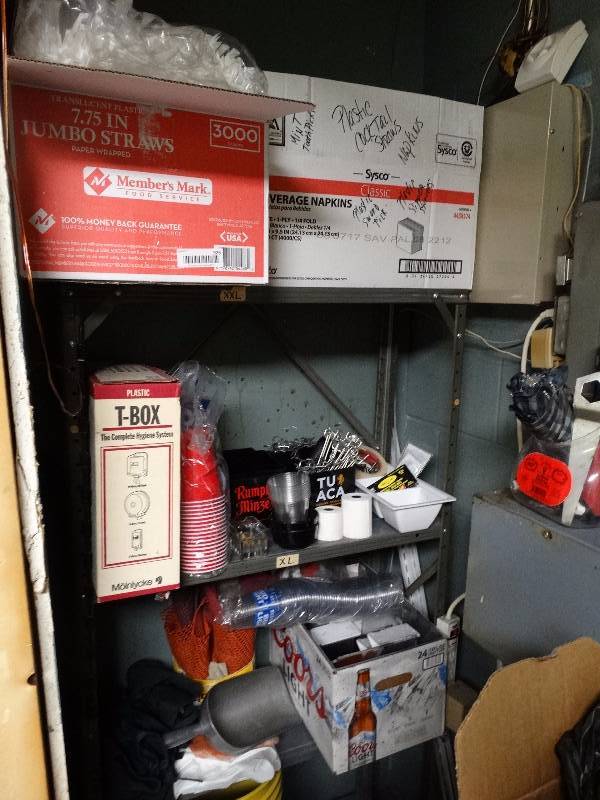 lot 926 image: Metal shelf w contents- case of straws, table tents, bar supplies, misc.
