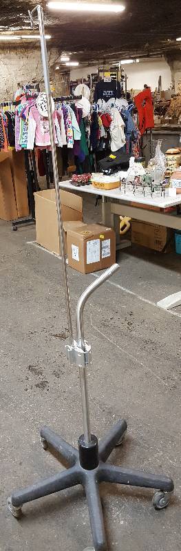 lot 6416 image: Stainless steel shaft on this adjustable height IV lines hospital stand with heavy base and casters.