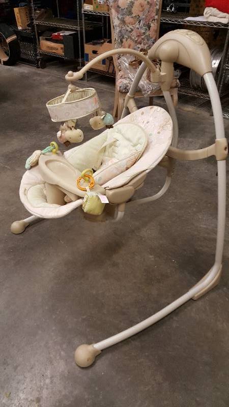 lot 5956 image: Bright Starts Baby Swing. Music and movements work. Can be disassembled to store or move