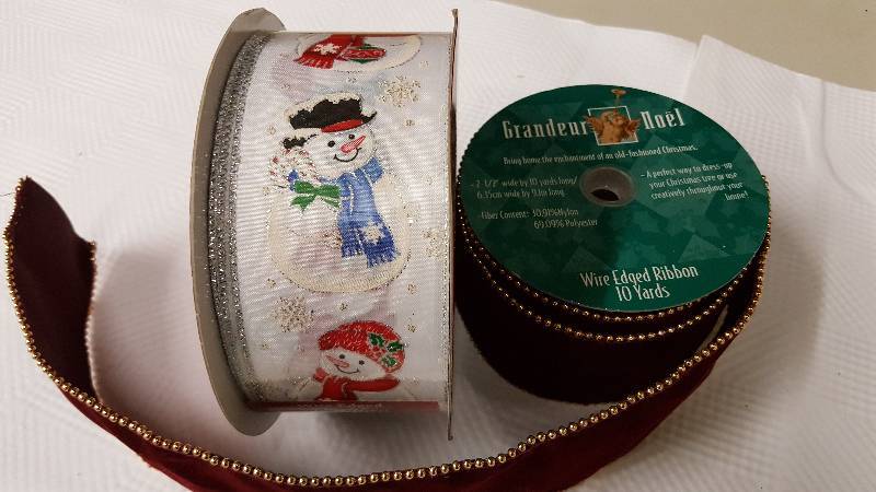 lot 5957 image: New bolts of Christmas ribbon.  Snowman is wired edged and 50 Yards (Never opened) and Maroon is wired edged and is 10 yards (New)