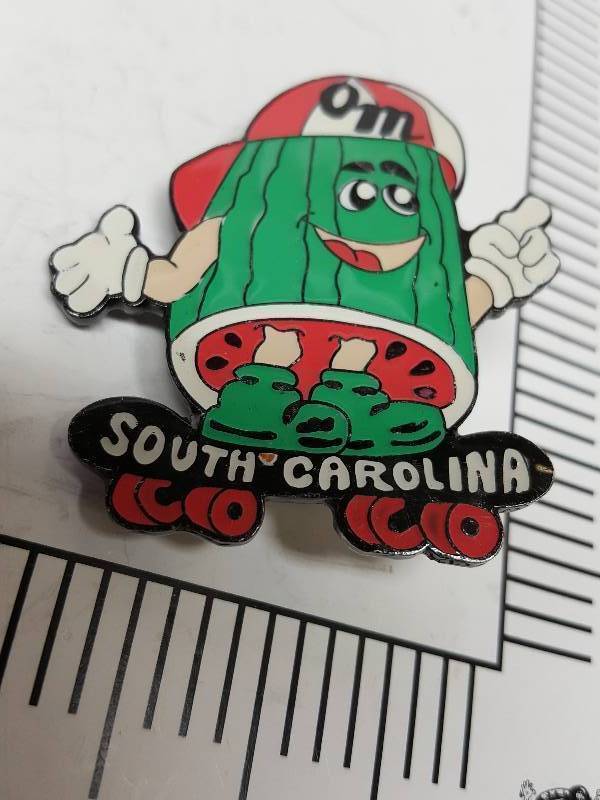 lot 8714 image: Another one of those collectable hat or lapel pins most are finished with wild porcelain colors.