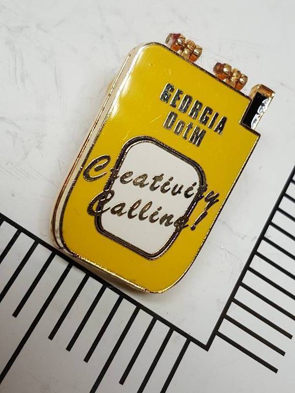 lot 8738 image: Another one of those collectable hat or lapel pins most are finished with wild porcelain colors.