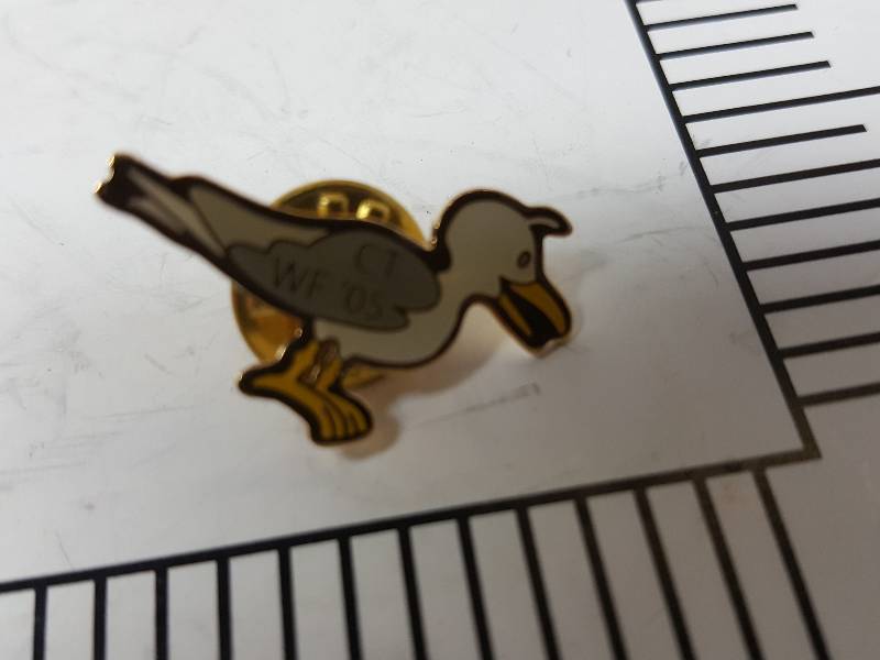 lot 8741 image: Another one of those collectable hat or lapel pins most are finished with wild porcelain colors.