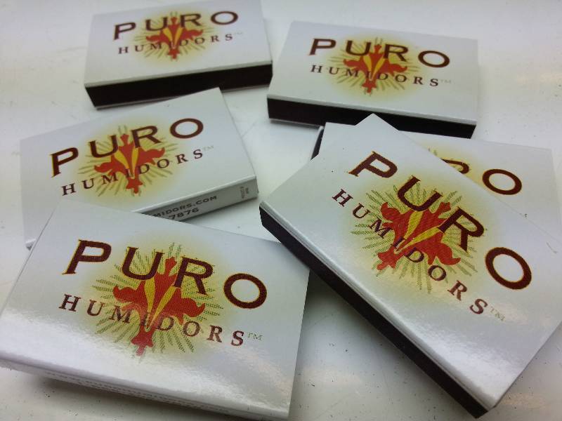 lot 9004 image: 6 small boxes of the promotional matches with the Premium Puro cigar Humidors.
