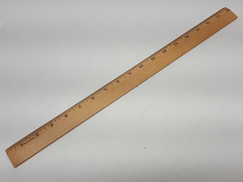 lot 9192 image: Good old fashioned wood desk ruler with metal strip on one side for drawing or cutting along the edge.