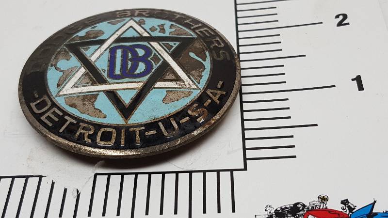 lot 6057 image: The porcelain has been chipped slightly off this Dodge Brothers radiator emblem