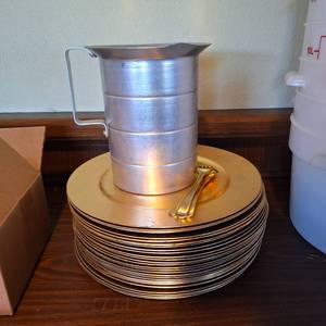 lot 37347 image: Lot of Gold Tone Plates And Tin Measuring Cup