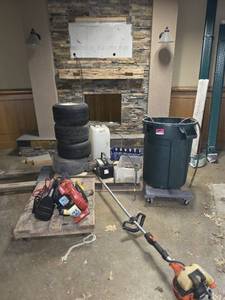 lot 81637 image: Assorted Lot W Weed Eaters, Dollys,  Jumper Cables  Blower  5 Tires  Battery  Fireplace Mantel And More