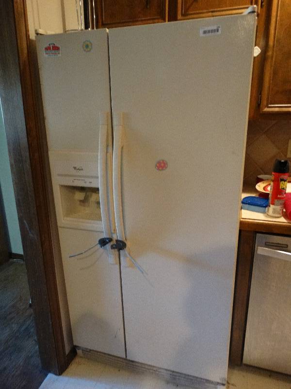 lot 299 image: Whirlpool side by side Refrigerator.