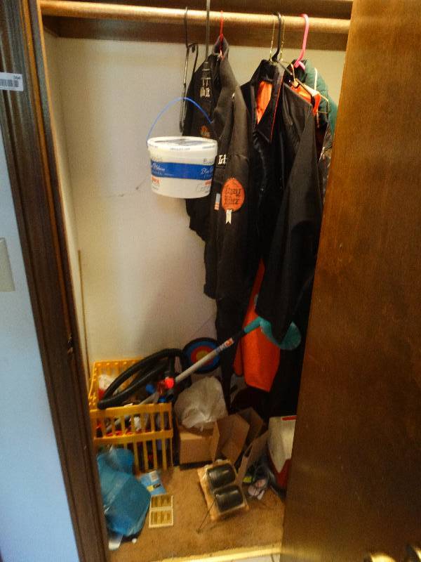 lot 364 image: Contents of closet- Jackets, ice chest, rotisserie, vacuum