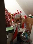 Lot of various Christmas items under stairs