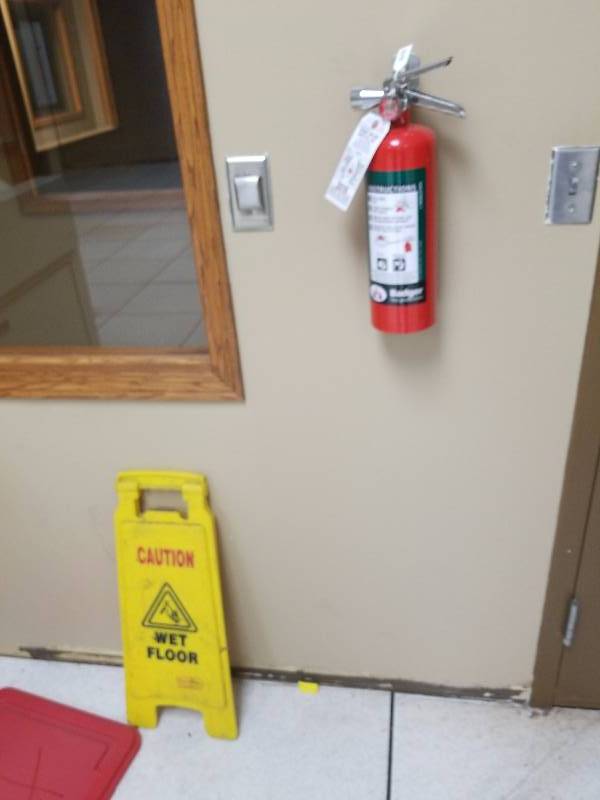 lot 5620 image: Fire extinguisher and wet floor sign
