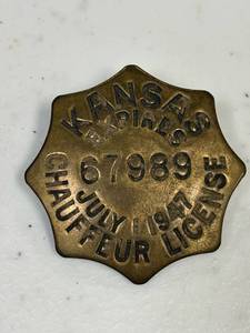 lot 31 image: 1947 Kansas chauffeur license badge, 67989