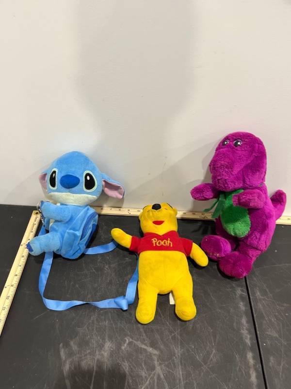 lot 1065 image: Bundle of 3 Plush - Barney, Winnie the Pooh, & Stitch