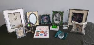 lot 42 image: Metal with Enamel Decorator Frames, Large Arora Borealis Stone on Stand, Crystal Prism Obelisk Figurine, Emerald Glass Cut Stone, Crystal Tear Drop Sun Catcher, Gem Stone Guide Book, & Large Metal Embellished Frames
