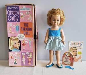 lot 51 image: Vintage 1959 Chatty Cathy The Talking Doll by Mattel - #282231- with Original Box, Booklet, and Registration Card - Including Dress, Shoes & Comb. Eyes Open & Close properly. Pull String Mechanism needs repaired, Pull Ring is Missing.
