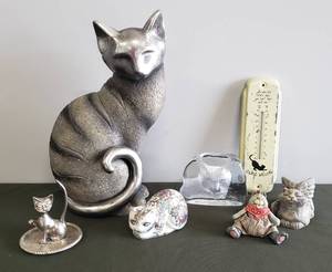 lot 86 image: Large Resin Cat Figurine, Cat in Overalls Shelf Sitter, Angel Kitty Res-Stone IndoorOutdoor Figurine, Small Hand Painted Porcelain Cat, Interpur Silver Metal Ring HolderTray, Frosted Crystal Cat Paperweight, & Strays Welcome Metal Outdoor Thermometer