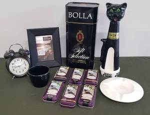 lot 109 image: Vintage 1960s Flying Saucer Ashtray, Beehive Planter, Black Photo Frame, American Alarm Company Retro Design Alarm Clock, Vintage KATZ Jim Beam Cat Decanter, Bolla Double Wine Bottle Tin, & Wine Lovers Chocolate Tins