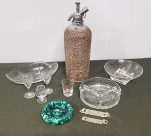 lot 115 image: Vintage Bar Ware Metal Caged Soda Decanter, Glass Divided NutCandy Dishes, Measuring Shot Glass, Etched Crystal Stemmed Sherry Glasses, 2 HAMMS Beer Bottle Openers, Green Ceramic Ashtry, & Brandy Shot Glass
