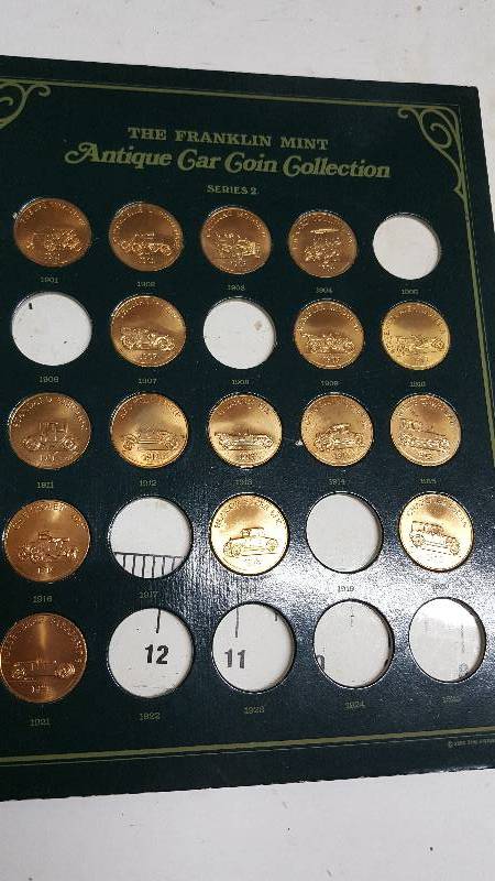 lot 5883 image: Sheet with a few missing of The Franklin Mint Antique Car Coin Collection, Gold Coins