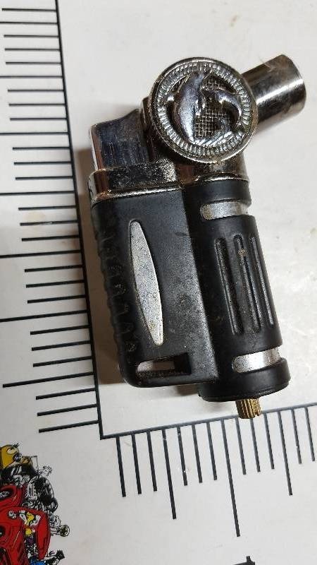 lot 5852 image: Torch style lighter with dolphins on it.