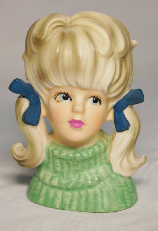 lot 7315 image: Lady Head Vase - Young Lady w pony tails and a sweater This one is rare See Photos