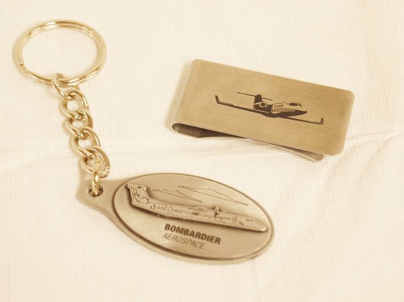 lot 2327 image: Air Plane Memorabilia - Key Chain Bombardier and Jet Money Clip - Wow