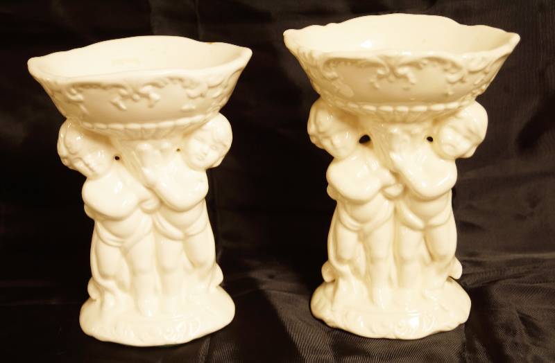 lot 2474 image: Beautiful Set of Candle Holders - White Ceramic w cherubs holding the pillar - nice