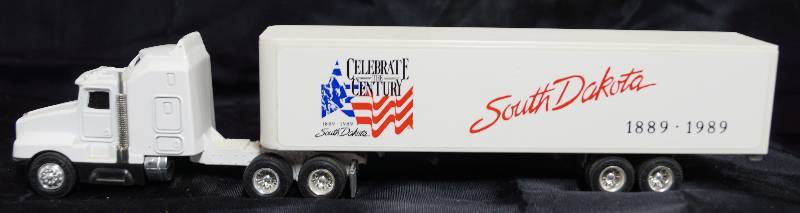 lot 7271 image: ERTL Die Cast Kenworth Replica T600A - South Dakota 1889-1989 Celebrate the Century - Semi Truck & Trailer - WOW