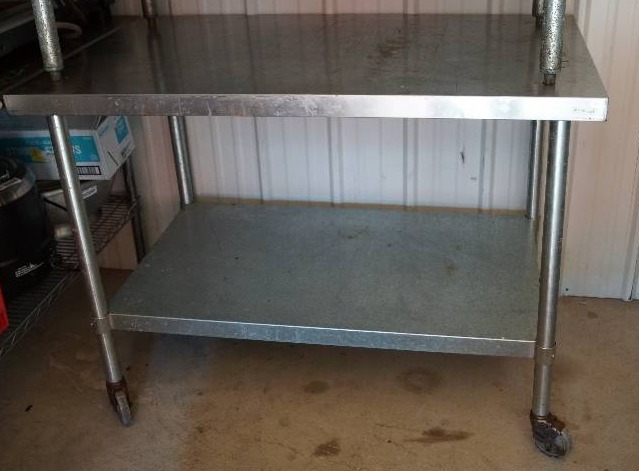 lot 4040 image: Stainless 4 foot Restaurant Table w bottom shelf on locking casterswheels -