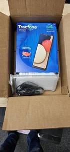 lot 52105 image: rack phone 6.5 inch samsung galaxy a 02 smartphone with 1500 top text data garden party 11- 00A006-Retail-$89.99