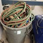 Lot of acetylene torch hoses and 30 gallon can of miscellaneous