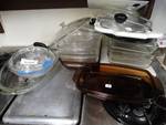 Large lot of glass baking dishes, lids, trays, & cutting boards.