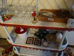 Contents of bakers rack- Decor items/ stemware/floral