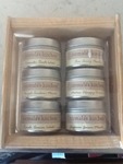 Set of spices in round tins and wooden case