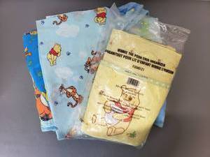 lot 416 image: Winne the Pooh Crib Quilt, Crib Organizer and Fabric Swatches