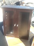 Nice wall cabinet with two shelves and glass front one door glass is cracked