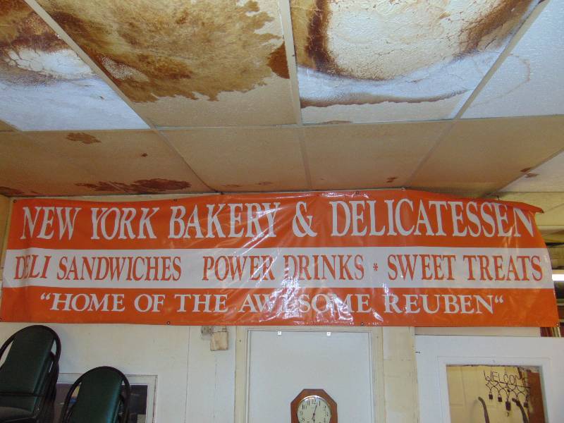lot 8065 image: (2) ct. lot New York Bakery & Delicatessen Banners (1) approx 12 x 33, (1) approx 8 x 33 Home of the Awesome Reuben