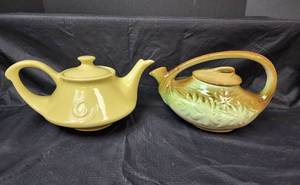 lot 123 image: Vintage 1940s McCoy BreenBrown Daisy Pattern Teapot and Vintage Yellow Musical Teapot (music box does not play)