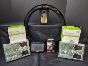 lot 273 image: (2) NIB Baby Jogger Graco Car Seat Adapters Click Connect, New Steering Wheel Cover, NIB Monster Bluetooth Car Locator, (2) New Execupak Executive Keyless Entry and Security Systems, NIB Bicycle Bottle Holder, and TomTom