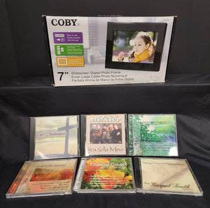 lot 315 image: NIB Coby 7 Widescreen Digital Photo Frame and Gospel CDs