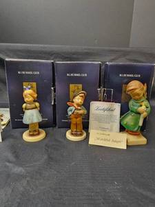 lot 353 image: Goebel Figurines - Watchful Angel (with box and certificate of authentication), Lucky Fellow (with box), and Two Hands One Treat (with box and certificate of authentication)