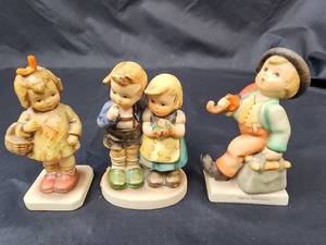 lot 364 image: Goebel Figurines - I Brought You a Gift 479 (no box), We Congratulate MJ Hummel Boy and Girl (no box - see pics for damage), and Merry Wanderer IU82 (no box)
