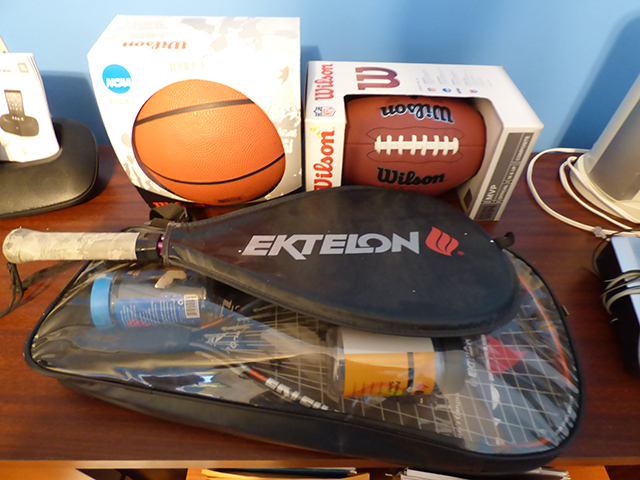 lot 1233 image: New Wilson Football and Basketball & 3 Rackets Ektelon Racketball case and balls.