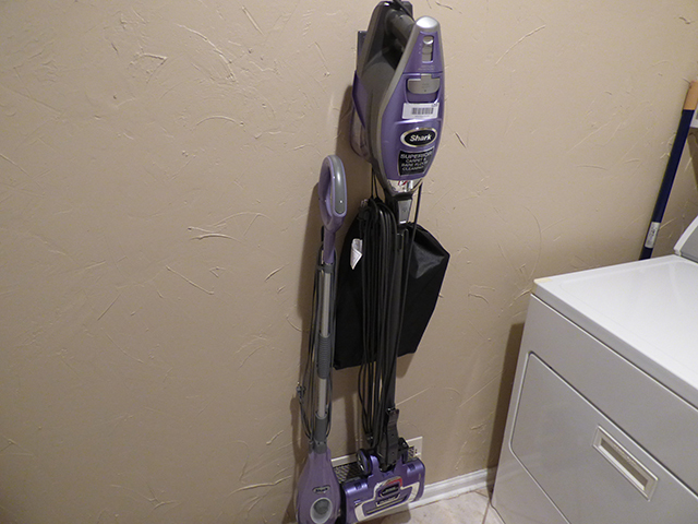 lot 1255 image: New Shark Superior CarpetBare Floor Vac with Attachments and Wall Mount