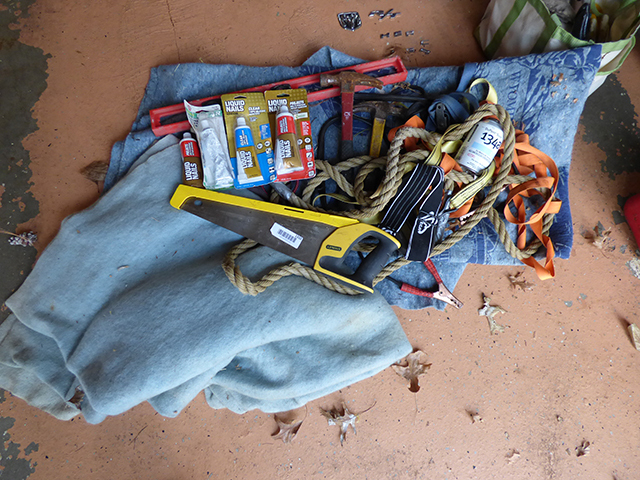 lot 1310 image: Large Lot Stanley Saw, Level, Can ac 134A Dupont, Goggles, Hammer, U-Haul Blanket, Mutiple Tie Down Sets, and 3 Liquid Nail Tubes