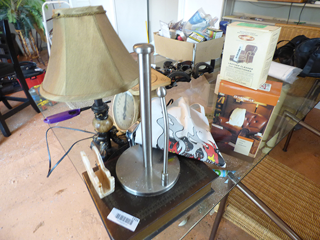 lot 1316 image: Misc. Assortment of Lamp, Stainless Paper Towel Holder, 2 Leather Cleaners, Scales,  Black Stapler, and Cooking Apron
